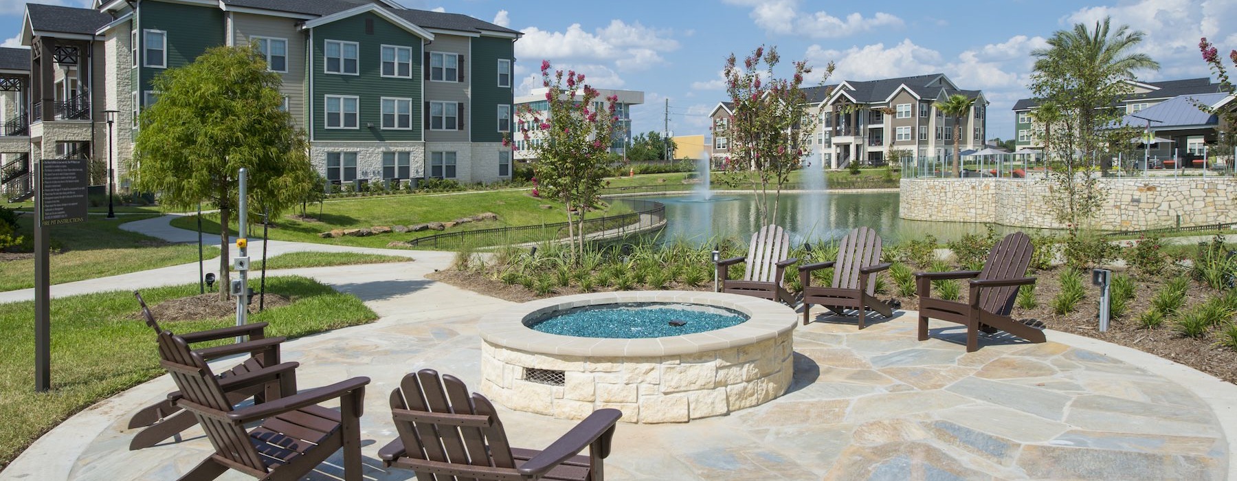 a patio with chairs and a fountain