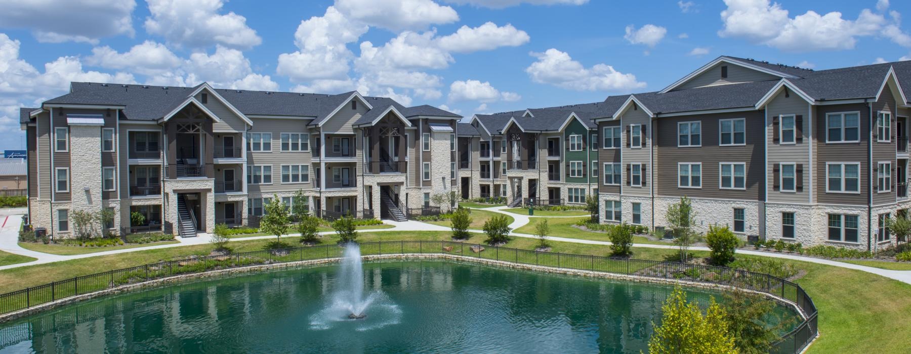 a large building with a fountain in the front